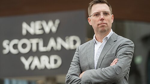 Photo of Rob Blackie in front of New Scotland Yard